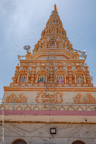 Hindu Temple showcasing the beautifully carved spires (shikhara) of the Malganga Devi, located on the banks of the Kukadi River near the famous natural rock potholes in Nighoj, India.
