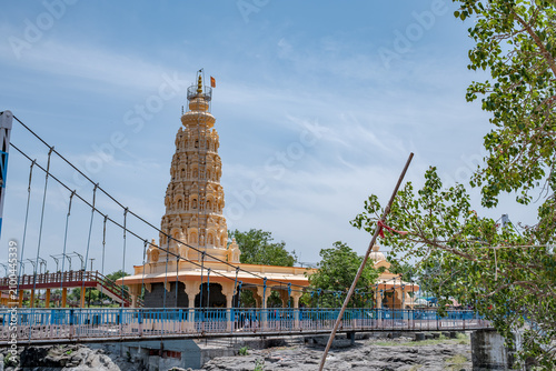 Hindu Temple showcasing the beautifully carved spires (shikhara) of the Malganga Devi, located on the banks of the Kukadi River near the famous natural rock potholes in Nighoj, India.