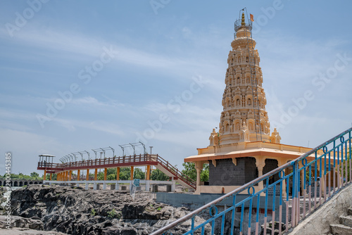 Hindu Temple showcasing the beautifully carved spires (shikhara) of the Malganga Devi, located on the banks of the Kukadi River near the famous natural rock potholes in Nighoj, India.