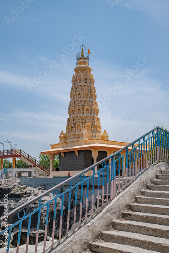 Hindu Temple showcasing the beautifully carved spires (shikhara) of the Malganga Devi, located on the banks of the Kukadi River near the famous natural rock potholes in Nighoj, India.