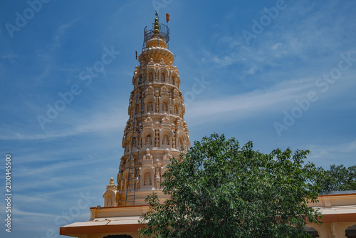 Hindu Temple showcasing the beautifully carved spires (shikhara) of the Malganga Devi, located on the banks of the Kukadi River near the famous natural rock potholes in Nighoj, India.
