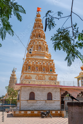 Hindu Temple showcasing the beautifully carved spires (shikhara) of the Malganga Devi, located on the banks of the Kukadi River near the famous natural rock potholes in Nighoj, India.