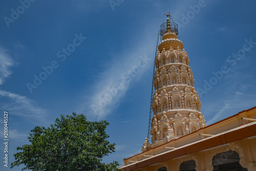 Hindu Temple showcasing the beautifully carved spires (shikhara) of the Malganga Devi, located on the banks of the Kukadi River near the famous natural rock potholes in Nighoj, India.
