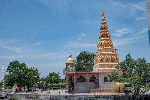 Hindu Temple showcasing the beautifully carved spires (shikhara) of the Malganga Devi, located on the banks of the Kukadi River near the famous natural rock potholes in Nighoj, India.
