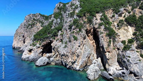 Fotografie Aerial view of the wild Gyali beach in Corfu, Greece, with dramatic high cliffs and crystal clear turquoise sea