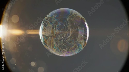 Close-up of Soap Bubble with Reflections and Light Effects.
