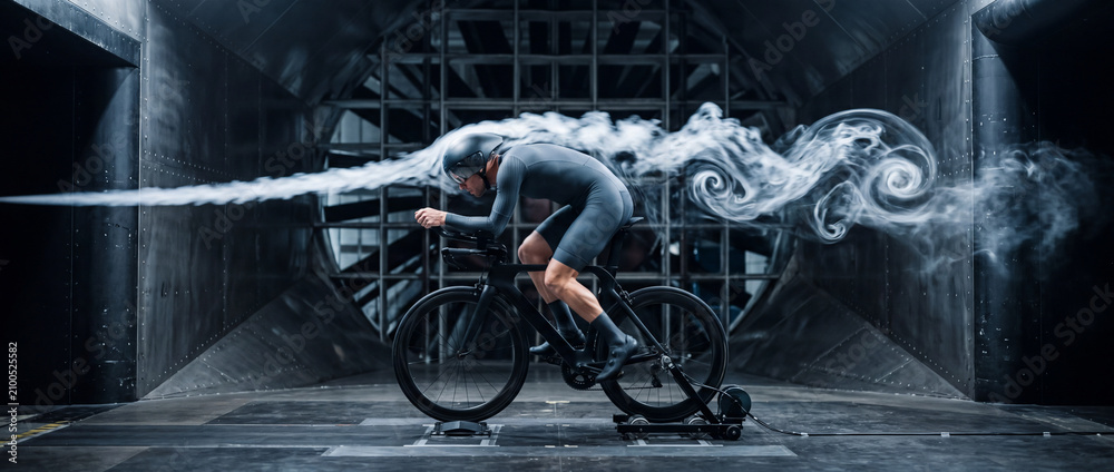Obraz premium Aerodynamic cyclist in wind tunnel testing high-speed time trial position on bike