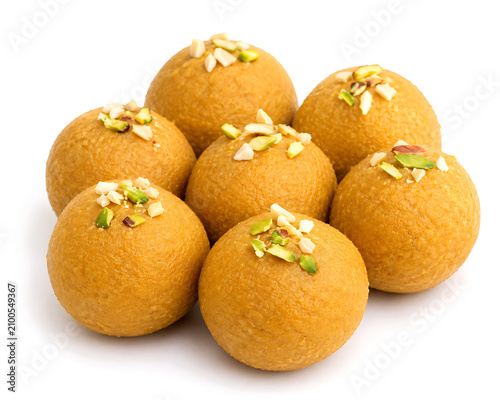 Besan ladoo  golden gram flour sweets topped with chopped nuts