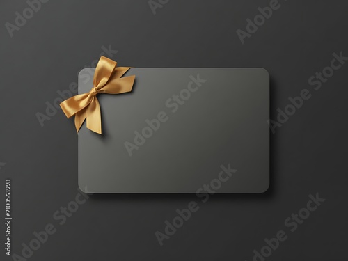 Blank gift card mockup with golden ribbon for branding and promotion, dark background