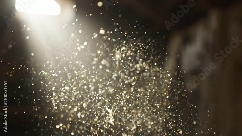 Close-up of Dust Particles Illuminated by Light in Dark Environment.