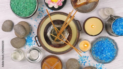 A composition of spa accessories slowly rotates around its axis. View from above.