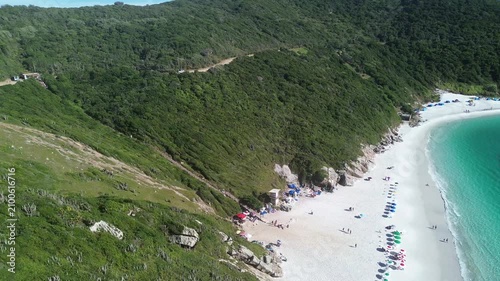 High-quality aerial footage overlooking Pontal do Atalaia Beach and its famous stairway in Arraial do Cabo, Rio de Janeiro, Brazil. Crystal-clear turquoise waters, lush vegetation.