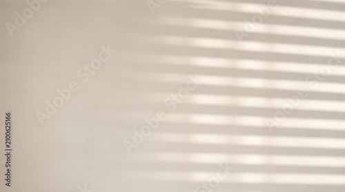 Parallel shadow lines falling on light beige wall