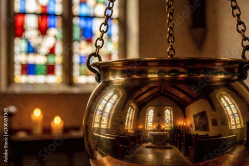 Abstract chapel reflection in a brass censer — selective focus captures a distorted sanctuary reflected in polished metal, warm golden tones and soft bokeh create a contemplative, conceptual image 