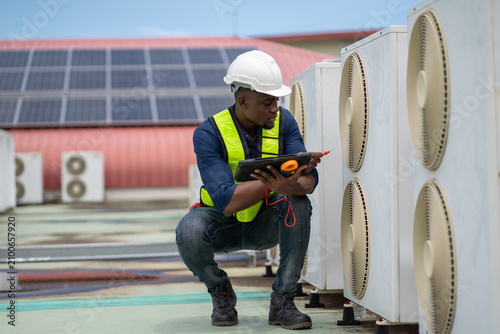Professional engineers inspecting and checking the industrial air conditioning cooling system and HVAC units of a major facility or commercial building