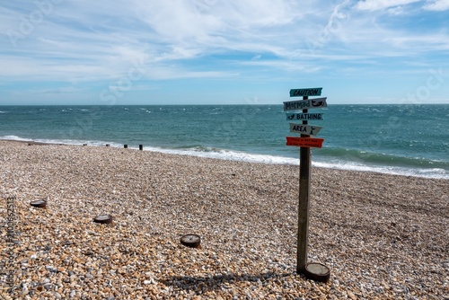 Schilderij op canvas Caution Mermaid swimming area sign on beautiful deserted beach at Selsey West Su