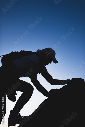 Konstfotografi Hiker silhouette scaling steep incline, showing strength and focused concentrati
