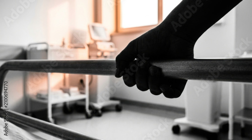 Close Up Of Hand Gripping Hospital Bed Rail In Medical Room