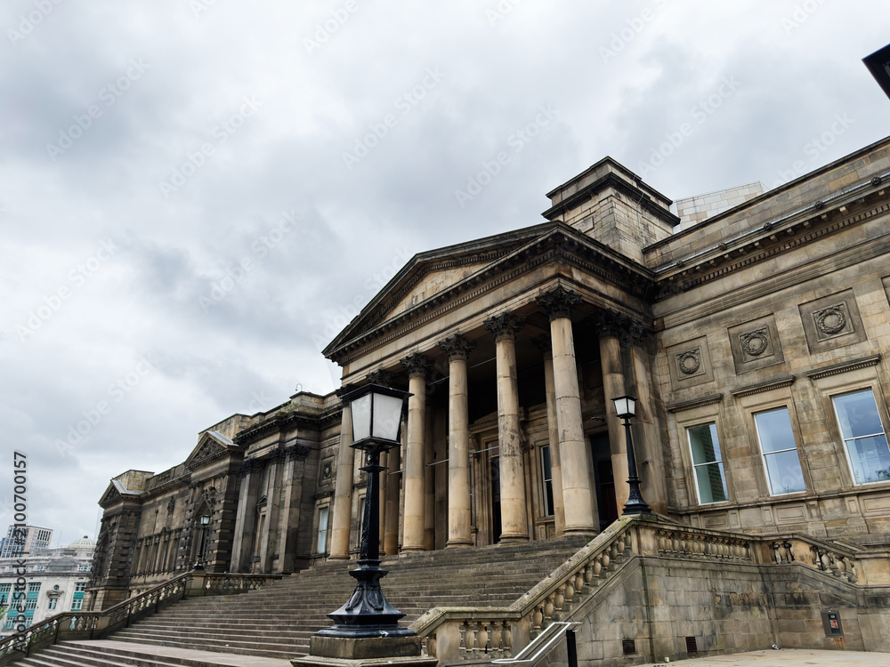 Obraz premium Historic neoclassical Central Library building with grand steps and tall columns in Liverpool, UK under a moody cloudy sky