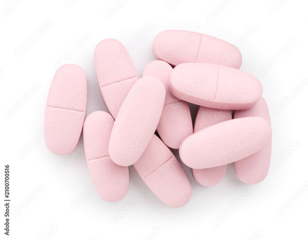 Obraz premium Pile of pink pills isolated on white, top view