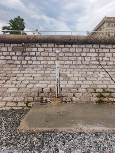 old brick wall of Nice shower pebles beach 
Côte d'Azur France 