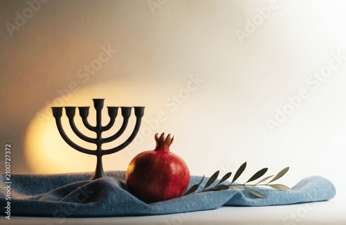 Elegant Jewish faith and heritage still life with menorah and pomegranate