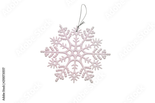 A snowflake-shaped Christmas pendant, made in pink and covered in glitter.