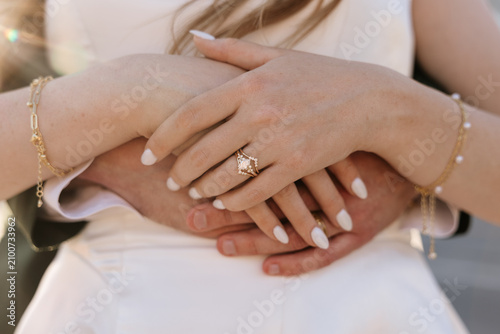 Close up of wedding bands on newlyweds