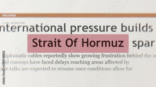Close up set of newspaper headlines reading strait of hormuz for breaking political news regarding united states and iran trade war conflict