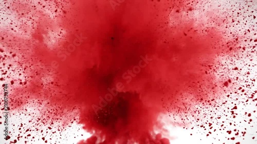 Red color powder explosion effect on a white background, slow motion with high-speed camera