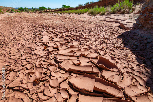 Close-up of drought area and cracked red clay in dry riverbed in the southwestern desert of the United States.