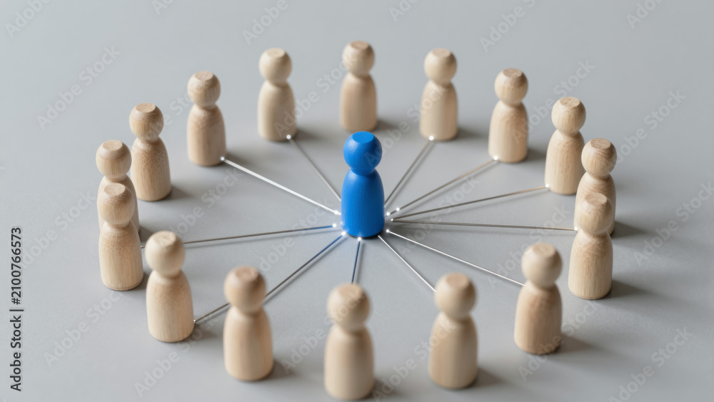 Obraz premium Blue Leader Figurine at Center of Connected Team Circle – Minimalist Business Concept for Leadership, Collaboration, and Network Management Presentations