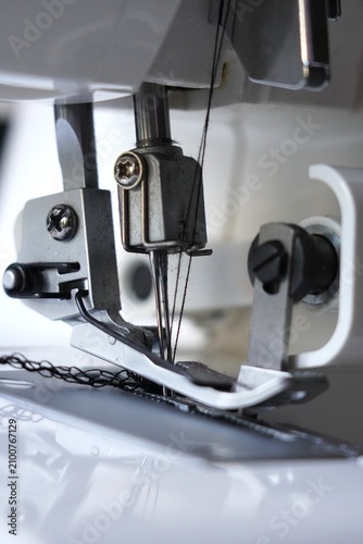 Konstfotografi Close-up of an overlock sewing machine needle and presser foot during stitching