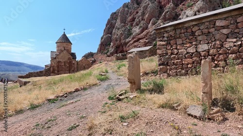 Ancient Noravank Armenian monastery rise against rugged mountains nestled against cliffs