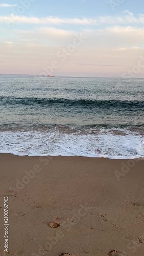 Woman on a beach with flowing boho skirt, ocean waves and pastel sunset sky, travel mindfulness and peaceful lifestyle