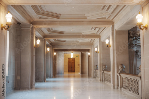 Elegant architectural details inside San Francisco City Hall, featuring ornate Beaux-Arts design, decorative columns, marble surfaces, intricate craftsmanship, and historic civic architecture.