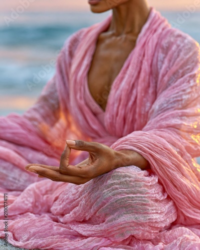 Soft pink robe drapes over calm, grounded posture
