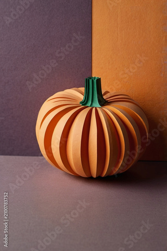 Minimal autumn pumpkin in paper cut style with copy space – modern seasonal 3D illustration, AI generated