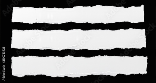 White ripped paper torn edges strips isolated on black background

