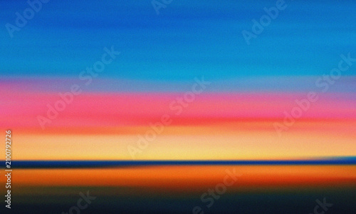 Abstract motion blur of a sunset over the ocean with vibrant colors
