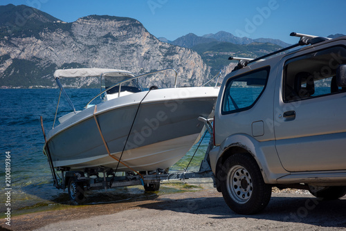 Boat launch at Lake Garda in Italy with vehicle on shore