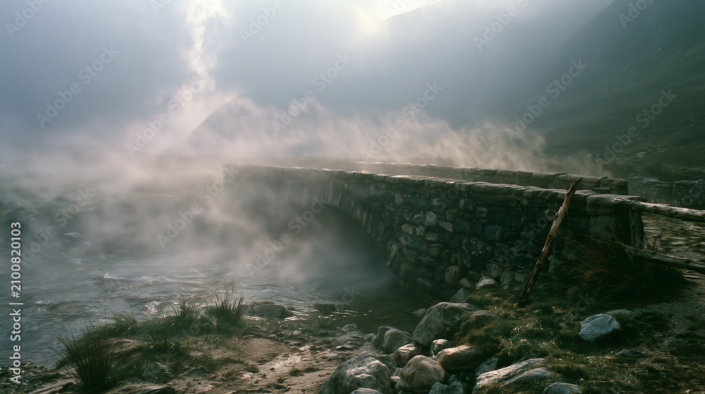 Obraz premium Weathered stone footbridge in swirling highland mist at golden overcast light
