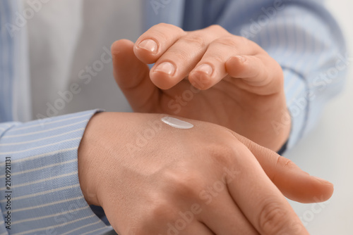 Canvastavla Person applying white hand cream for skin care and moisturizing, beauty and hygi