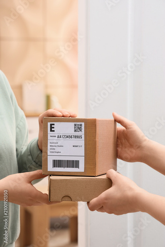 Young woman receiving parce...