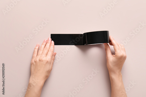 Female hands applying black...