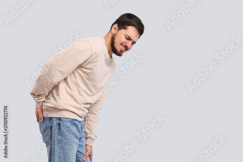 Young man with hemorrhoids ...