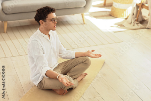 Young man meditating on yog...