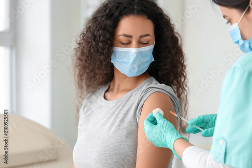 Female doctor vaccinating A...