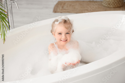Cute little girl with foam ...