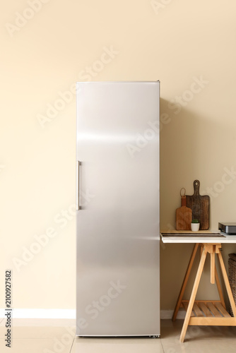 Modern fridge and table wit...